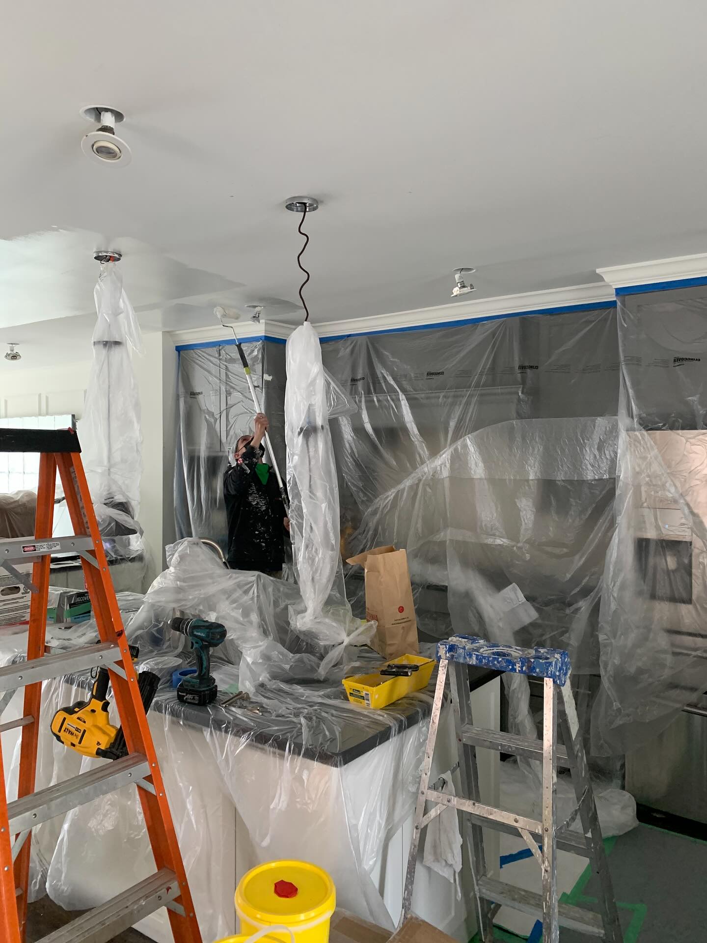 Professional painter taping and protecting surfaces before painting — Toronto Painters showing proper prep work process